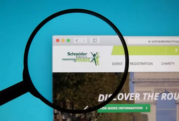 Schneider Electric Marathon de Paris logo on a computer screen with a magnifying glass