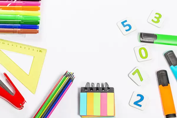 School supplies frame on white background with free space in the middle