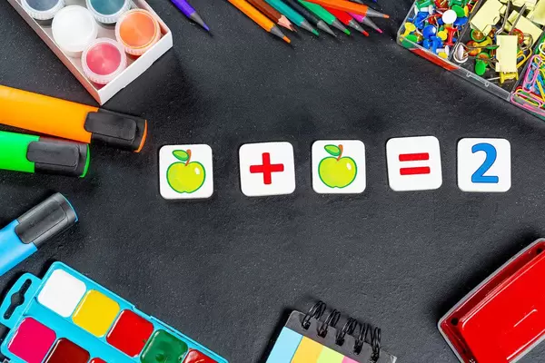 School supplies on the blackboard. Teacher's day background