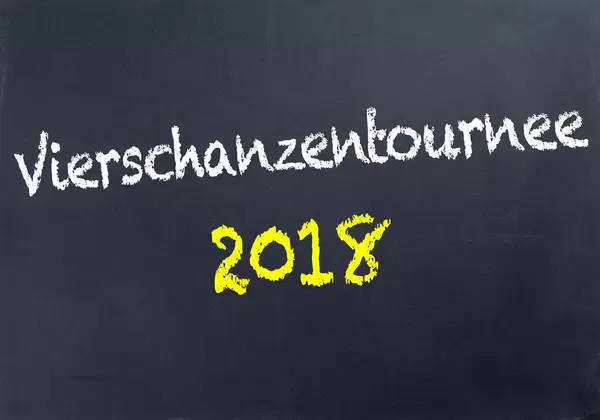 Schriftzug VIERSCHANZENTOURNEE 2018 in gelb und weiß auf schwarzer Tafel