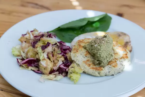 Scrambled tofu burger made with white beans with salad and herbs & spices