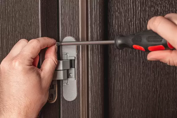 Screw tightening with a screwdriver, installation of furniture hinges for doors