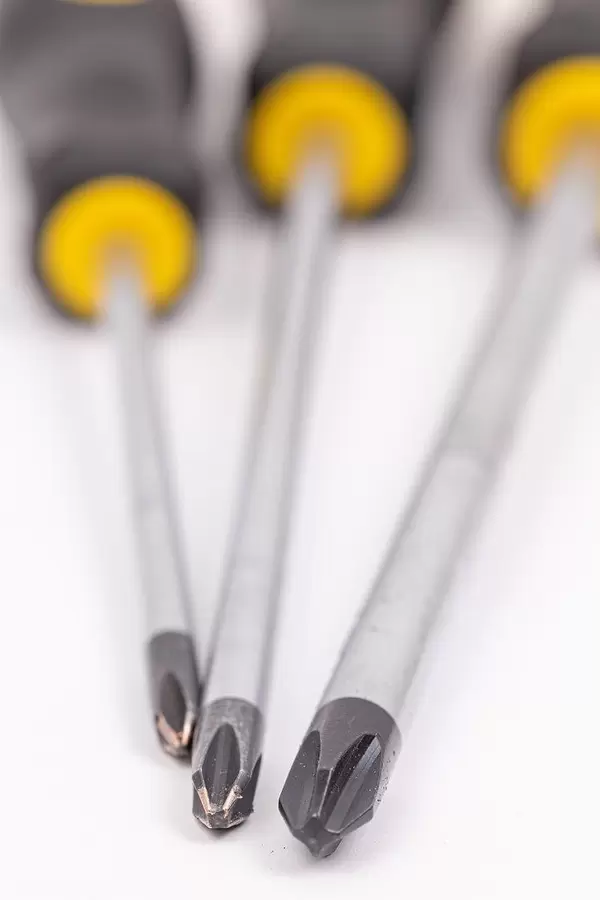 Screwdrivers above white background with shallow focus
