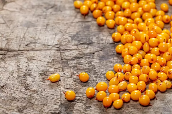 Sea buckthorn berries on old wooden background (Flip 2019)