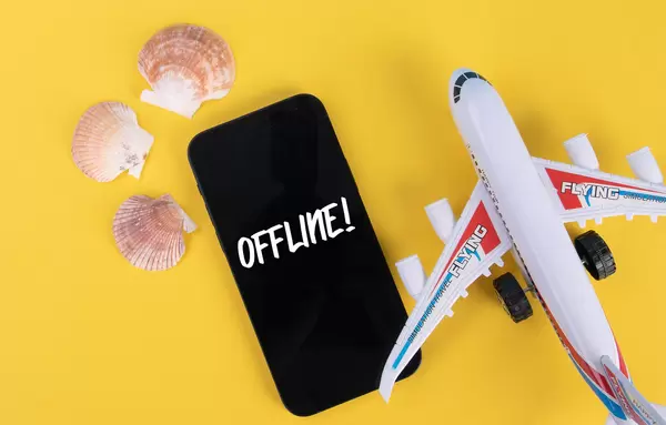 Sea shells, airplane and smartphone with Offline text