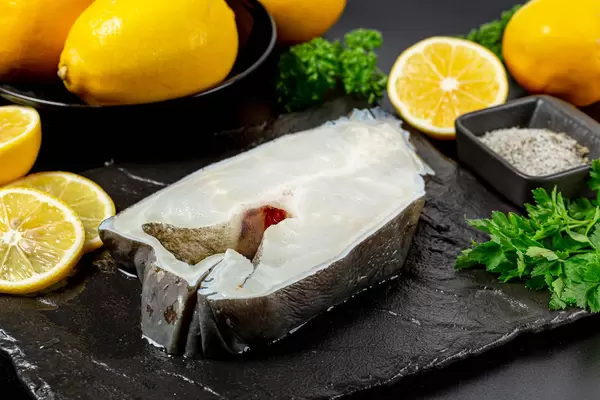 Seawolf or catfish steak with lemons and green parsley