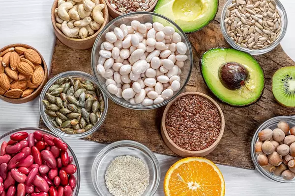 Seeds, nuts and fruit on an old kitchen Board. Top view