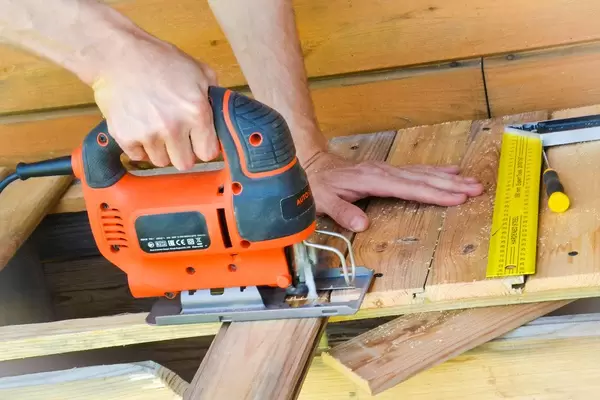 Selfmade wood work with jigsaw and old boards