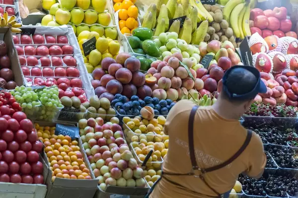 Seller checking his fruit at Danilovsky Market in Moscow