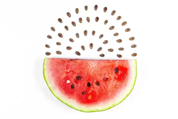 Semicircle of ripe red watermelon and seeds on white background