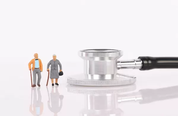 Senior couple with stethoscope on white background