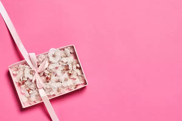 Sensitive spring background with tree blossoms and ribbon