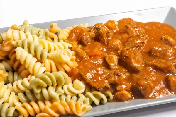 Served colorful Macaroni with meat Goulash