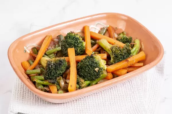 Served cooked Carrot with Green Beans Onions and Broccoli