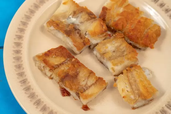 Served fried Alaska Pollock fish on the plate