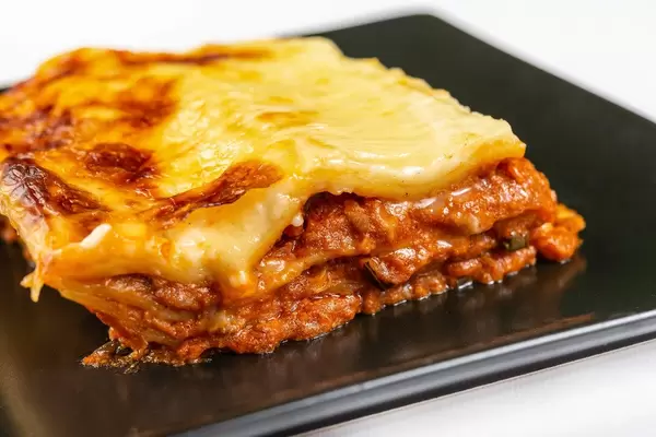 Served Lasagna on the black square plate (Flip 2019)