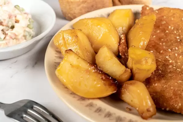 Served lunch with Fried Pork Meat with baked Potatoes and Vegetable salad