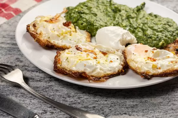 Served meal Cooked Spinach and Fried Eggs