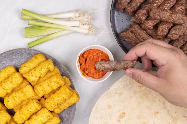 Served Meal on the table with hand above table