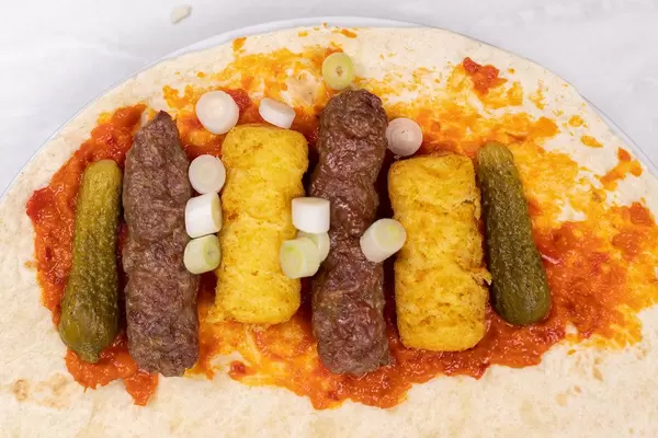 Served Meal on the table with Kebabs Potatoe Crockets and salad