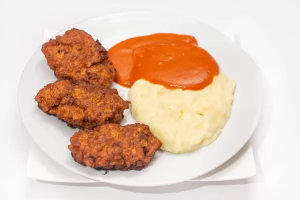 Served meal with meatballs tomato sauce and mashed potatoes on the white plate