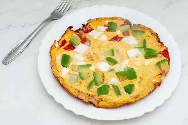 Served Omelet with Avocado Cheese and Tomatoes