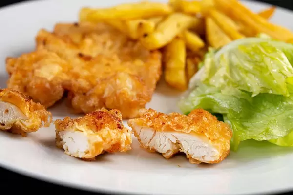 Served plate with Fried Chicken Meat and French Fries