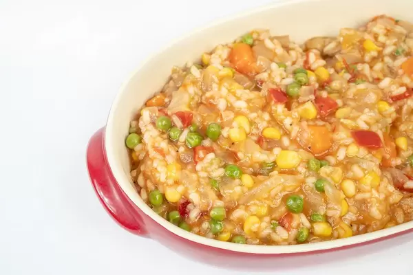 Served Risotto with Vegetables above white background