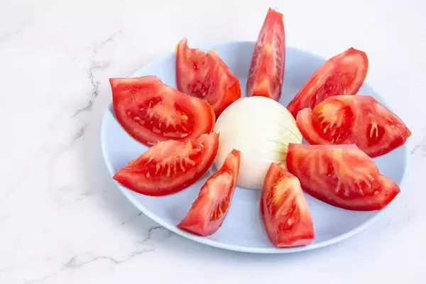 Served Tomato salad on the blue plate