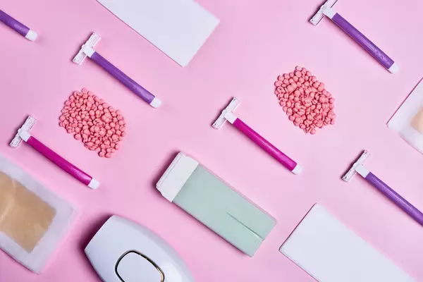 Set for hair removal accessories on pink. Flat lay