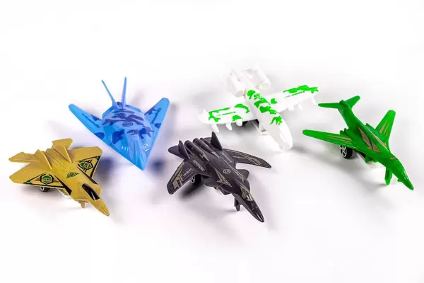 Set multi colored aircraft toys on white background