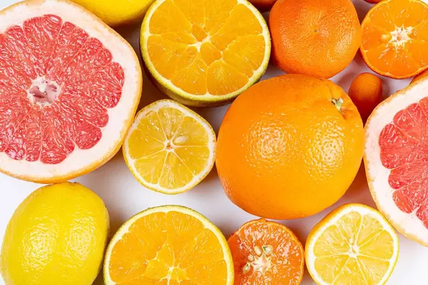 Set of different citrus fruits on a white background, top view