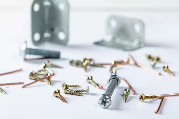 Set of different nails, screws, bolts on white background