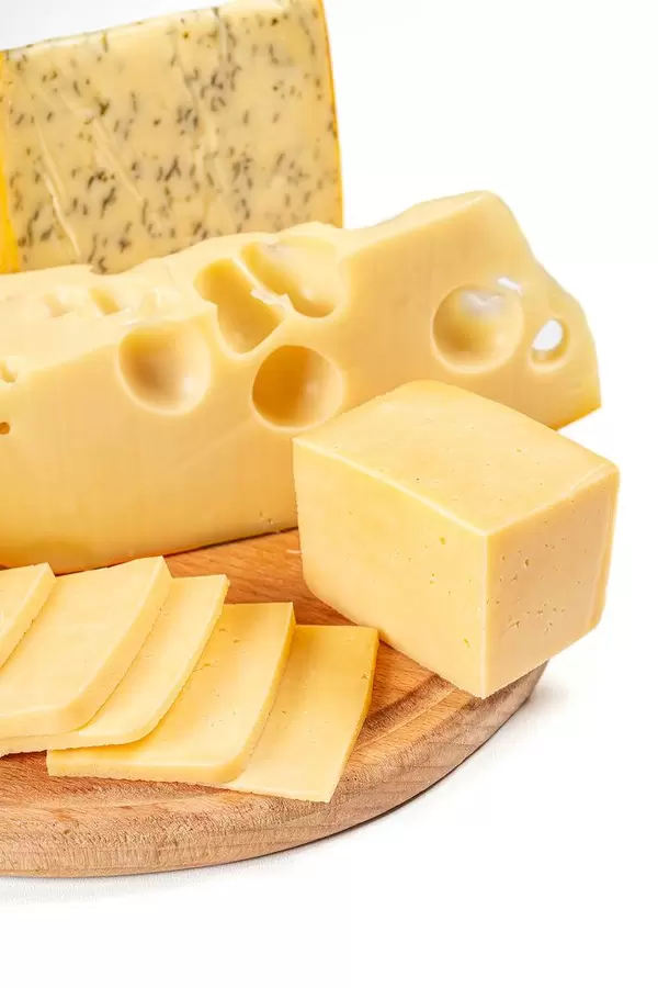 Set of different types of cheese on a wooden kitchen board, close-up (Flip 2020)