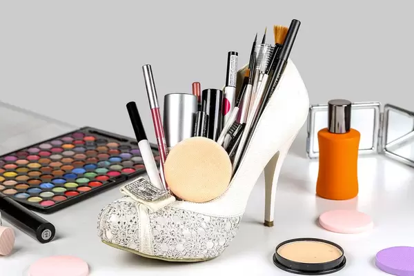 Set of different women's cosmetics with a white shoe