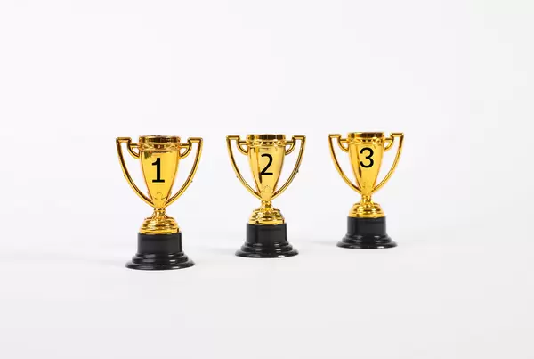 Set of golden trophies on white background