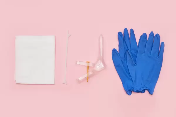 Set of instruments for gynecology - Vaginal speculum, medicine gloves, spatula. Feminine health diagnosis