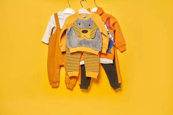 Set of kids clothes on yellow