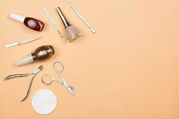 Set of manicure and pedicure tools on trendy pastel background. Professional instruments for nail care