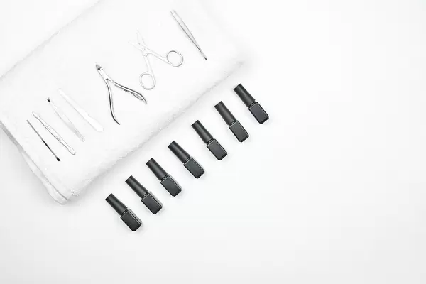 Set of nail polishing gels with professional manicure tools on white background