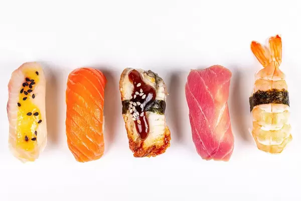 Set of nigiri with seafood on a white background, top view
