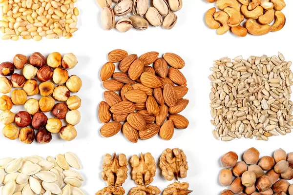 Set of nuts and seeds on white. Concept of natural healthy nutrition (Flip 2020)