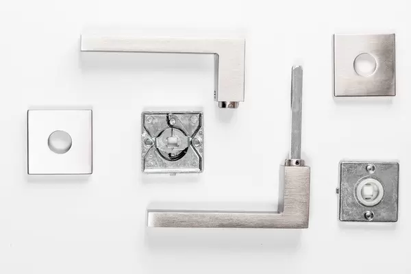 Set of parts to door handle on white background