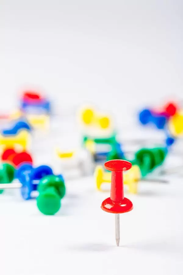 Set of push pins in different colors on white background