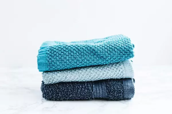 Set of three bath towels on white background