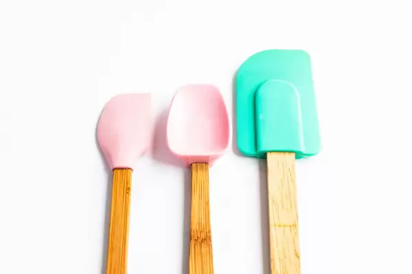 Set of three silicone spatulas on white background