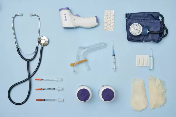 Set of various medical items and tools on bright blue background