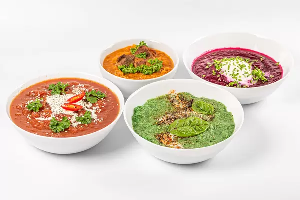 Set of various soups in white bowls