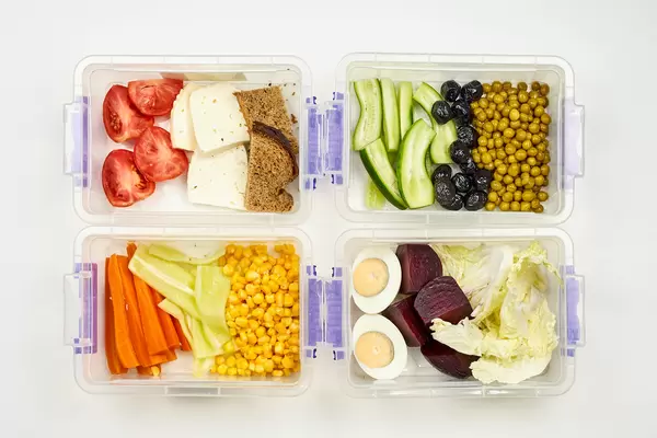 Set of vegetarian food packed in the lunchbox for four persons
