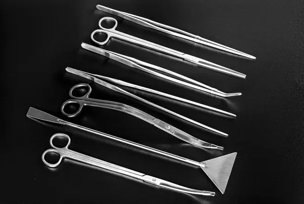 Set scissors and tweezers on a black background